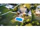 Expansive aerial view showcasing a large yard, inviting pool, and charming home at 166 Weldon Dr, Clayton, NC 27520