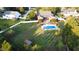Aerial view of backyard with pool, patio, expansive lawn, and shed at 166 Weldon Dr, Clayton, NC 27520