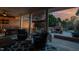 Inviting outdoor space with brick fireplace, lounge chairs, string lights, and tranquil backyard view at 166 Weldon Dr, Clayton, NC 27520