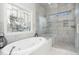 Luxurious bathroom showcasing a soaking tub and a glass-enclosed shower at 166 Weldon Dr, Clayton, NC 27520
