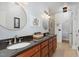 Bathroom features double sinks with granite counters, gold framed mirrors, and ceramic tiled shower at 166 Weldon Dr, Clayton, NC 27520