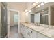 Bathroom with double sinks, granite counters, and ceramic tiled shower at 166 Weldon Dr, Clayton, NC 27520