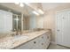 Bathroom with double sinks, granite counters, and ceramic tiled shower at 166 Weldon Dr, Clayton, NC 27520