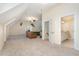 Large bonus room with plush carpeting, a seating area, and access to bathroom at 166 Weldon Dr, Clayton, NC 27520