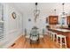 Inviting dining area with wood floors, stylish lighting, and a bar with seating at 166 Weldon Dr, Clayton, NC 27520