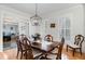 Bright dining room featuring wood floors, elegant lighting, and detailed trim at 166 Weldon Dr, Clayton, NC 27520