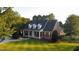 Charming brick home with a covered front porch, dormer windows, and well-manicured lawn at 166 Weldon Dr, Clayton, NC 27520