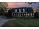 Charming brick home with manicured lawn, mature trees, and welcoming front porch at 166 Weldon Dr, Clayton, NC 27520