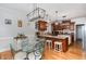 Well-appointed kitchen and dining area with wood floors, stylish lighting, and bar seating at 166 Weldon Dr, Clayton, NC 27520