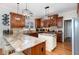 Spacious kitchen featuring granite countertops, custom cabinetry and modern light fixtures at 166 Weldon Dr, Clayton, NC 27520