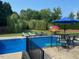 A backyard pool area with lounge chairs and an outdoor seating area, ideal for relaxation at 166 Weldon Dr, Clayton, NC 27520