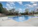 A backyard pool with mature landscaping and a pool house creating a private oasis at 166 Weldon Dr, Clayton, NC 27520