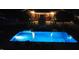 Tranquil pool illuminated at night, creating a serene backyard ambiance at 166 Weldon Dr, Clayton, NC 27520