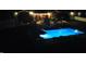 Beautifully lit backyard pool area at night with inviting lounge space at 166 Weldon Dr, Clayton, NC 27520