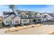 New townhome development showcasing modern farmhouse exteriors and landscaping at 3929 Willow Gate Way, Raleigh, NC 27604