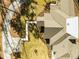 Aerial view of the home and property with mature trees and landscaping, a long driveway and concrete walkway at 1414 Whippoorwill Ln, Chapel Hill, NC 27517
