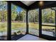 View of the exterior back porch with views of the manicured backyard and surrounding trees at 1414 Whippoorwill Ln, Chapel Hill, NC 27517