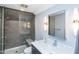Modern bathroom features a glass shower, a white countertop vanity, and contemporary lighting fixtures at 1414 Whippoorwill Ln, Chapel Hill, NC 27517