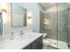 The bathroom has a glass enclosed shower with silver fixtures, a gray vanity, a white sink, and ample lighting at 1414 Whippoorwill Ln, Chapel Hill, NC 27517