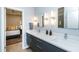 Modern bathroom featuring double sink vanity, bright lighting, and stylish gray cabinetry at 1414 Whippoorwill Ln, Chapel Hill, NC 27517