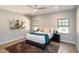 Comfortable bedroom with natural light, stylish decor, and hardwood floors at 1414 Whippoorwill Ln, Chapel Hill, NC 27517