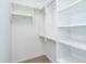 Walk in closet with shelving and silver clothes rods for ample space at 1414 Whippoorwill Ln, Chapel Hill, NC 27517