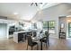 Open-concept living space with dining area, modern kitchen, and natural light from large windows at 1414 Whippoorwill Ln, Chapel Hill, NC 27517
