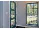 Bright entryway features a green door, black framed window with a garden view, and light hardwood floors at 1414 Whippoorwill Ln, Chapel Hill, NC 27517