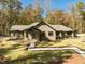 Beautiful home with brick, black trim and a long walkway with mature trees and landscaping at 1414 Whippoorwill Ln, Chapel Hill, NC 27517