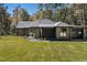 One-story brick home featuring a green front door, dark roof, a well-maintained yard, and attached garage at 1414 Whippoorwill Ln, Chapel Hill, NC 27517
