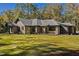 Charming brick home with a well-maintained lawn, complemented by mature trees and landscaping at 1414 Whippoorwill Ln, Chapel Hill, NC 27517