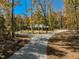 Beautiful single-story home with a long, winding driveway surrounded by mature trees, offering a private and secluded setting at 1414 Whippoorwill Ln, Chapel Hill, NC 27517