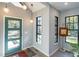 Bright foyer featuring a modern teal front door and ample natural light from multiple windows at 1414 Whippoorwill Ln, Chapel Hill, NC 27517