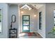 Bright and modern foyer with a skylight, a teal front door, and stylish light fixtures at 1414 Whippoorwill Ln, Chapel Hill, NC 27517