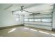 Spacious garage with a white door, windows and a concrete floor with natural lighting at 1414 Whippoorwill Ln, Chapel Hill, NC 27517