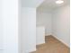 Bright white hallway with hardwood floors provides a minimalist aesthetic and leads to other areas of the house at 1414 Whippoorwill Ln, Chapel Hill, NC 27517