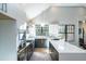 Bright kitchen featuring an island, stainless steel appliances, and contrasting white and gray cabinetry at 1414 Whippoorwill Ln, Chapel Hill, NC 27517