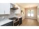 Bright kitchen featuring stainless steel appliances, stylish backsplash, and an adjacent dining area at 1414 Whippoorwill Ln, Chapel Hill, NC 27517