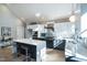 Bright modern kitchen with stainless appliances, center island, and eat-in barstool seating at 1414 Whippoorwill Ln, Chapel Hill, NC 27517