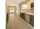 Modern kitchen featuring stainless steel appliances, gray cabinets, a white countertop and light wood floors at 1414 Whippoorwill Ln, Chapel Hill, NC 27517