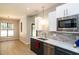 Well-lit kitchen with stainless steel appliances, double sink, and plenty of counter space at 1414 Whippoorwill Ln, Chapel Hill, NC 27517