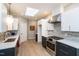Contemporary kitchen equipped with stainless steel appliances, light countertops, and modern cabinetry at 1414 Whippoorwill Ln, Chapel Hill, NC 27517
