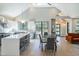 Open-concept living space featuring modern kitchen, dining area, and a cozy seating area bathed in natural light at 1414 Whippoorwill Ln, Chapel Hill, NC 27517