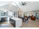 Open-concept living space with vaulted ceilings, skylight, hardwood floors, and a modern kitchen at 1414 Whippoorwill Ln, Chapel Hill, NC 27517