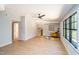 Bright, neutral living room with light hardwood floors, a ceiling fan, and a comfortable reading nook with natural light at 1414 Whippoorwill Ln, Chapel Hill, NC 27517
