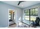 Bright home office space with large window view and sleek glass desk, perfect for a modern workspace at 1414 Whippoorwill Ln, Chapel Hill, NC 27517