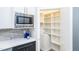 Kitchen with a pantry for storing food, and drink, featuring stainless steel microwave and appliances at 1414 Whippoorwill Ln, Chapel Hill, NC 27517