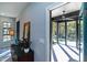 Entryway view of the screened-in porch with ceiling fan, wood floors, and scenic backyard views at 1414 Whippoorwill Ln, Chapel Hill, NC 27517