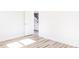 Bright bedroom featuring hardwood floors, white walls, and white door at 70 Little Creek Dr, Lillington, NC 27546