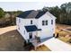 Aerial view of a two-story home with white siding, a dark roof, and a two-car garage at 70 Little Creek Dr, Lillington, NC 27546